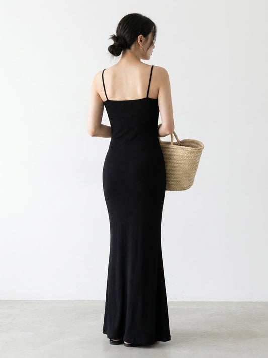 Back view of a woman in a black spaghetti strap dress
