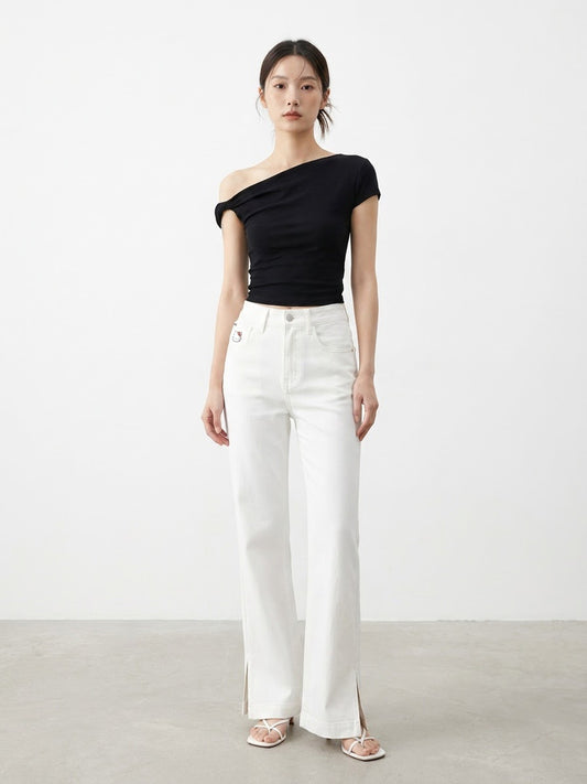 Mirror selfie of model wearing white wide-leg cropped jeans