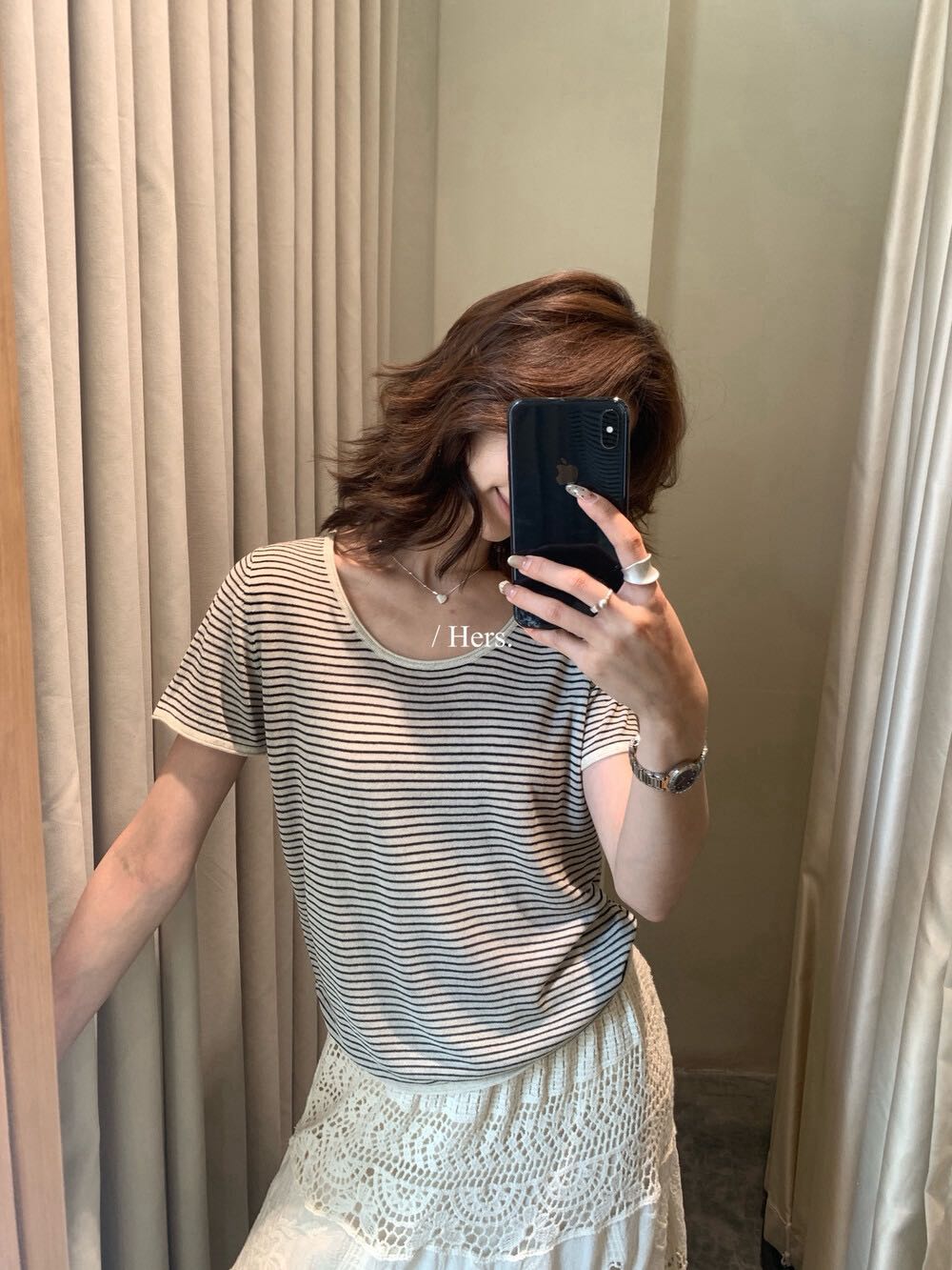 Woman wearing an oatmeal striped round neck short sleeve linen knit shirt