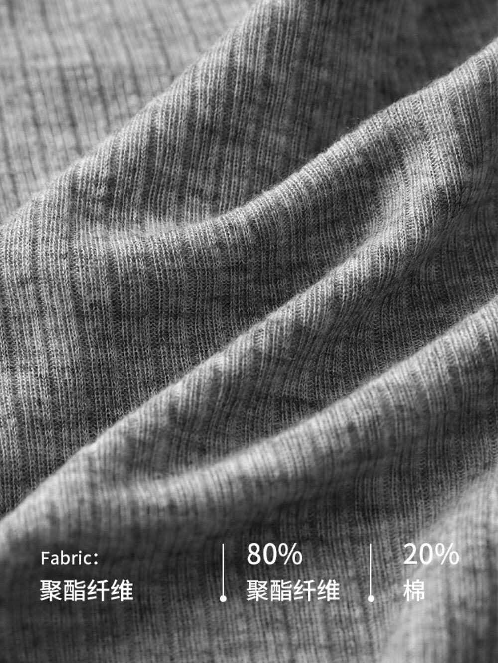 Close up of grey ribbed fabric showing material composition