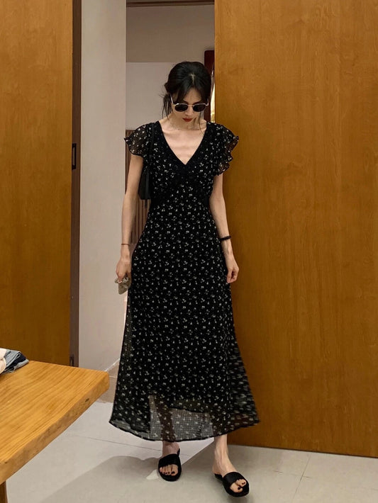 Model wearing an elegant black floral maxi dress