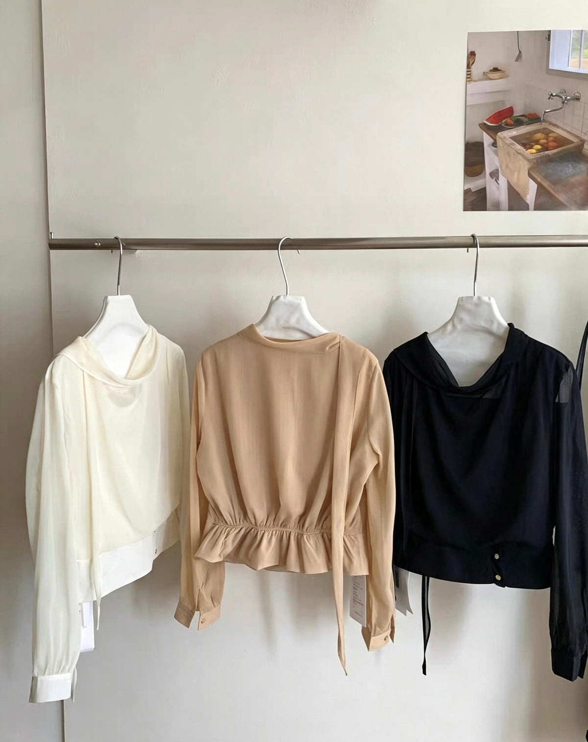 Back and front details of beige, white, and black draped neck blouses