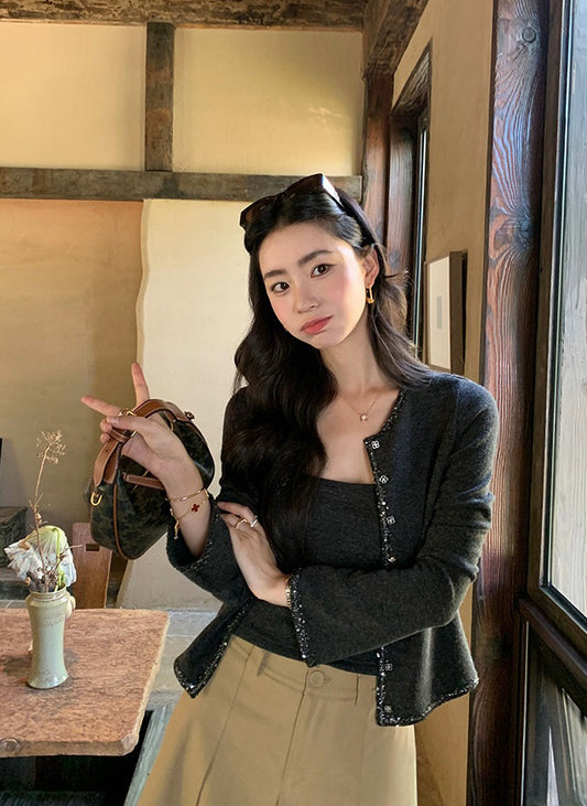 Model wearing a dark grey embellished cardigan and matching camisole