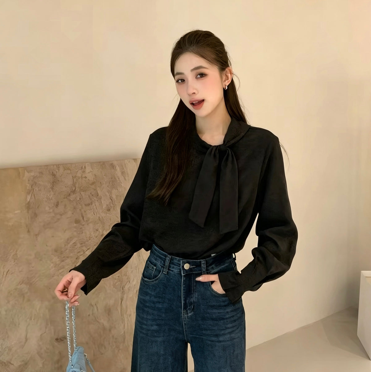Model wearing black tie-neck long-sleeve shirt