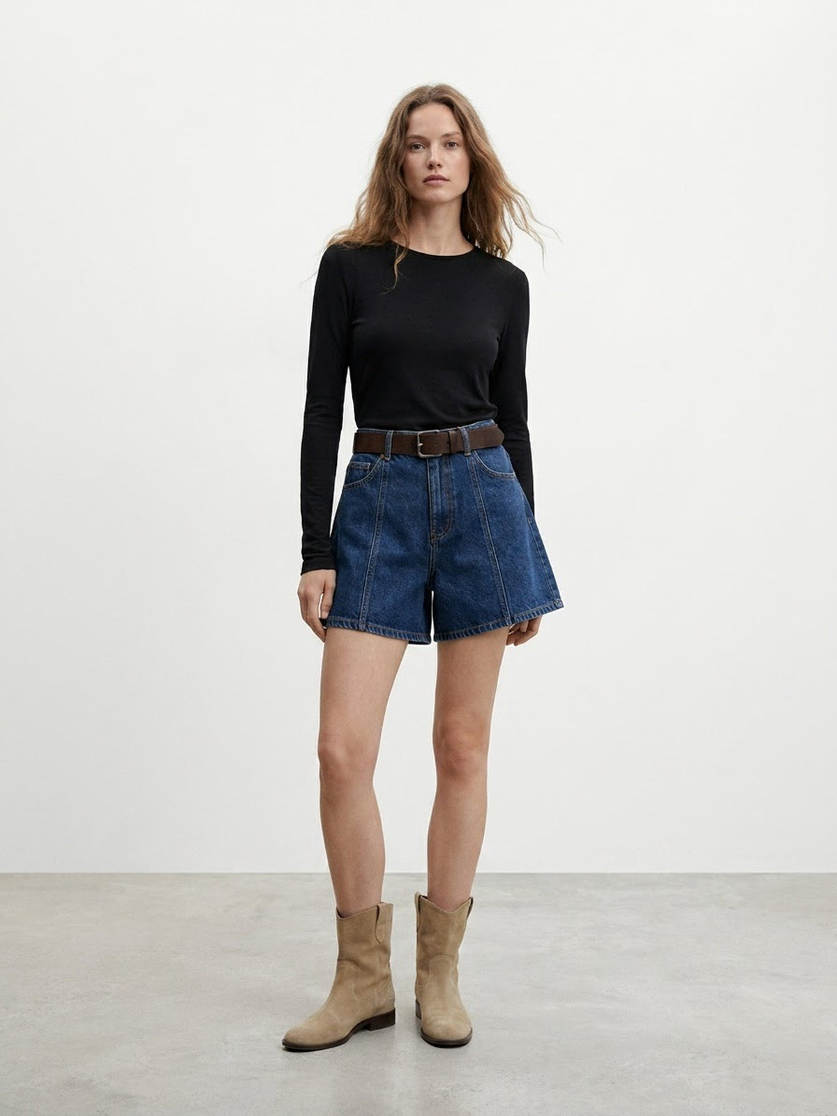 Back view of model wearing early autumn high-waisted denim shorts