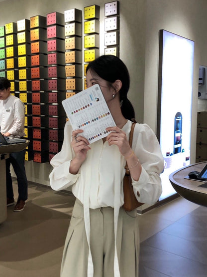 French-style pleated blouse with small buttons