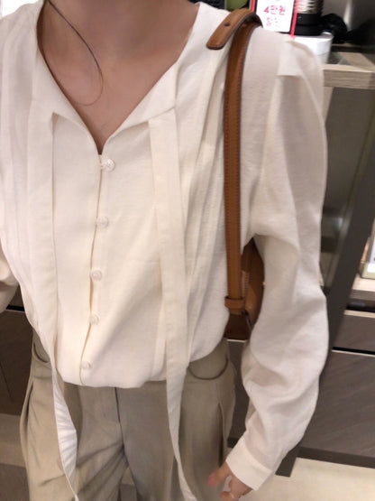 French-style pleated blouse with small buttons