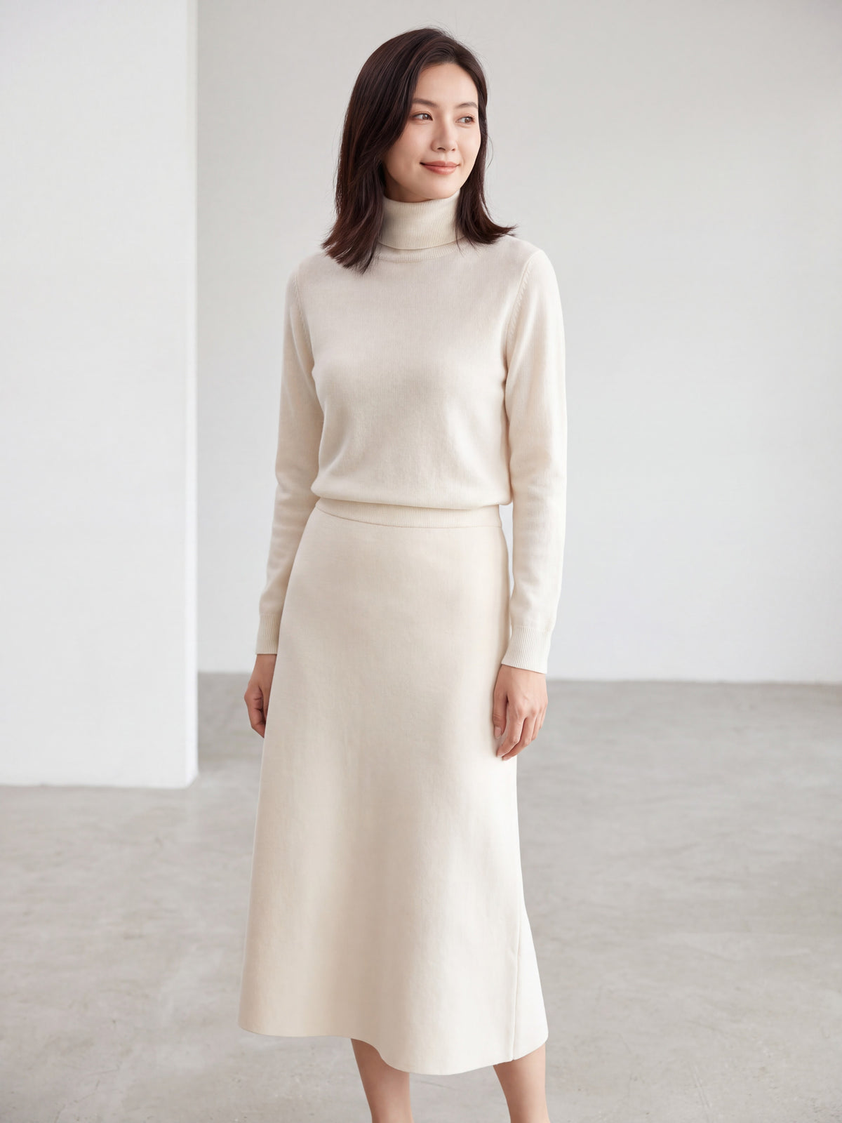 Five thickened knit skirts in light pink, off-white, dark grey, brown, and black hanging on a rack