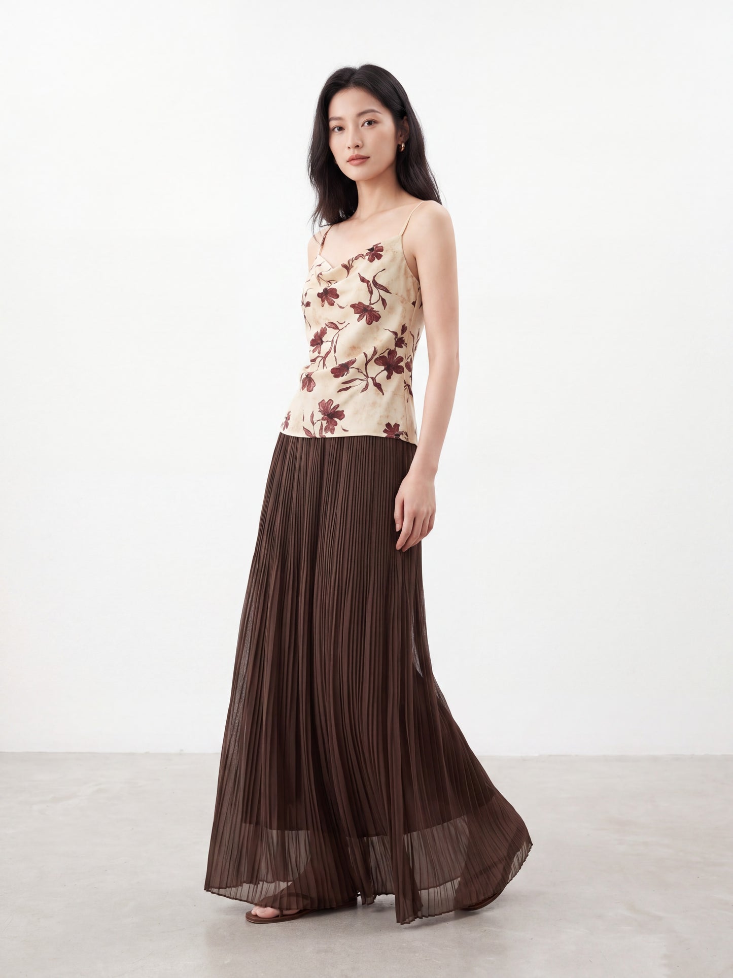 Model wearing a dark brown pleated maxi skirt