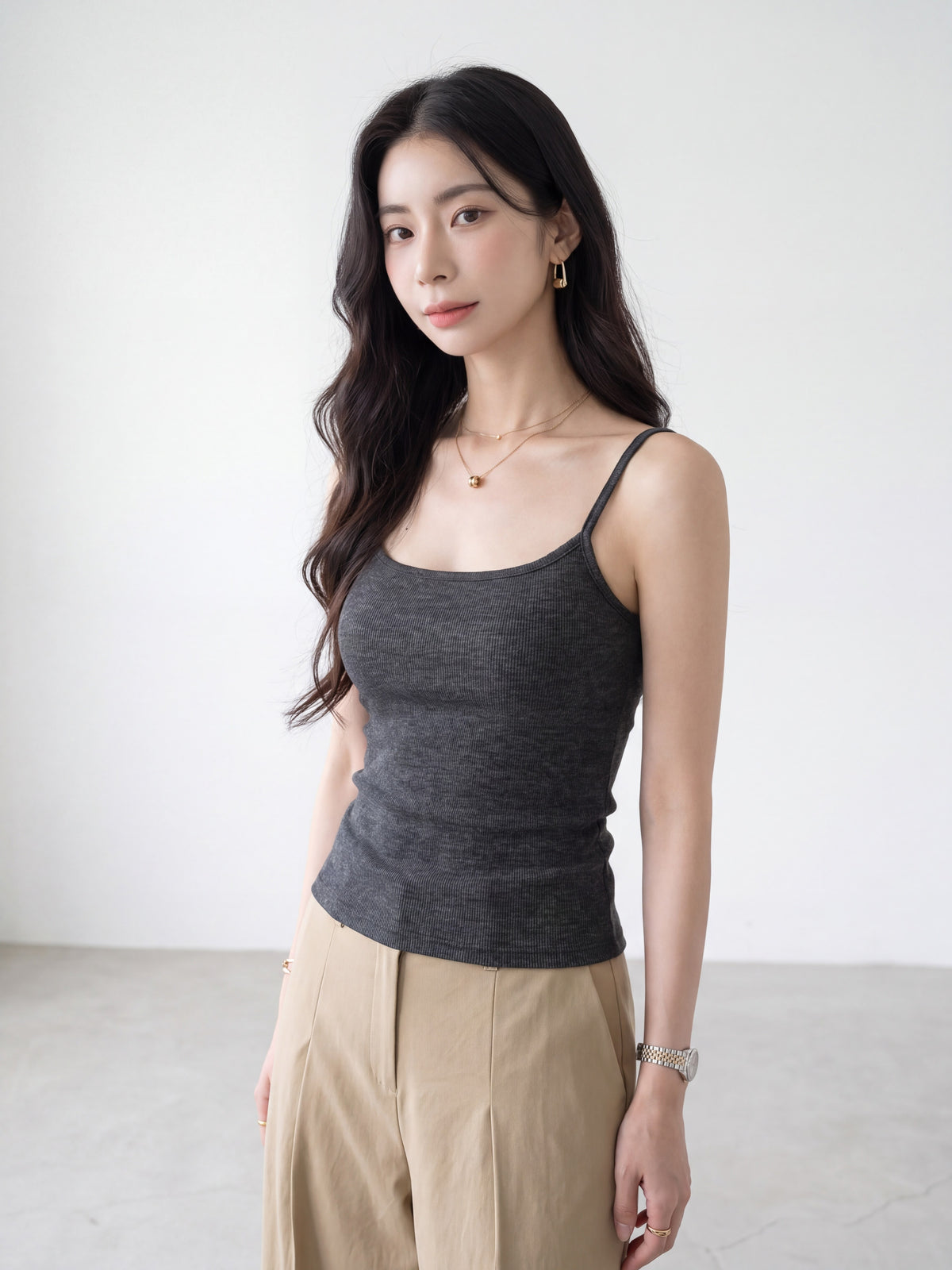 Woman wearing a dark grey camisole top