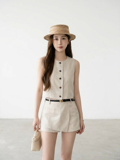 Woman wearing beige elegant vest and skort two-piece set in a restaurant