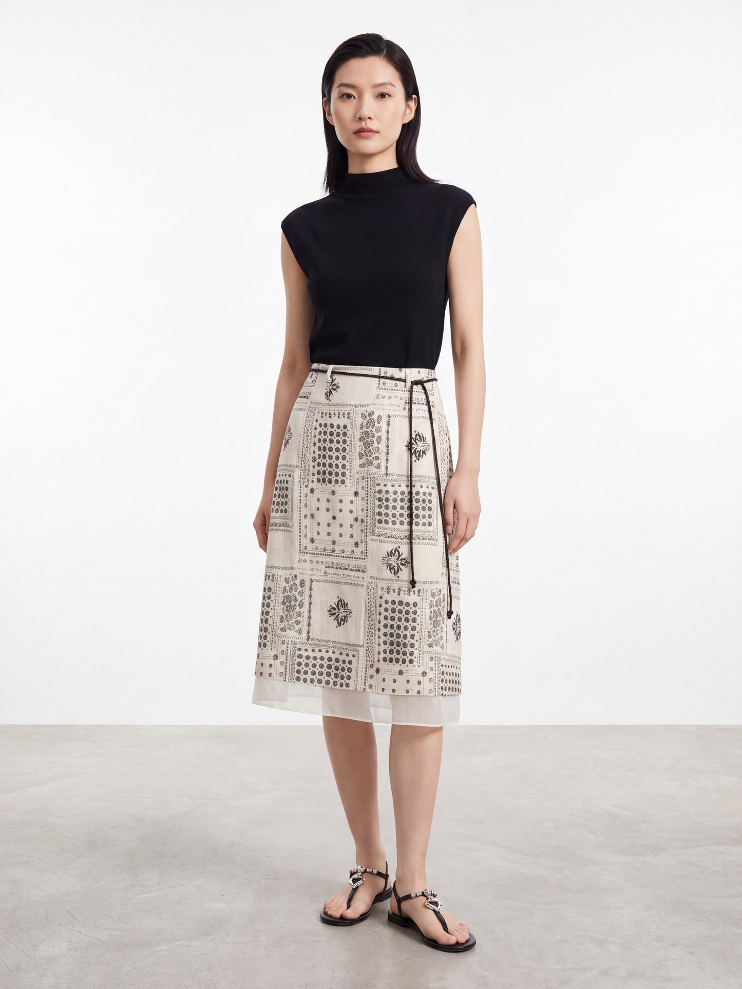 Woman wearing a vintage print midi skirt with a thin black belt