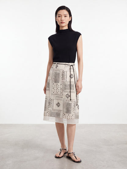 Woman wearing a vintage print midi skirt with a thin black belt