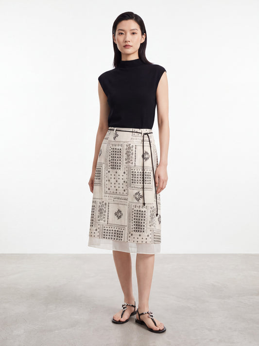 Woman wearing a vintage print midi skirt with a thin black belt