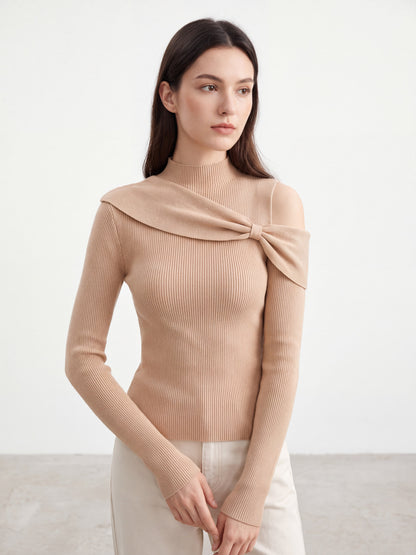 Model wearing orange-pink bow twist cold shoulder knit top, posing
