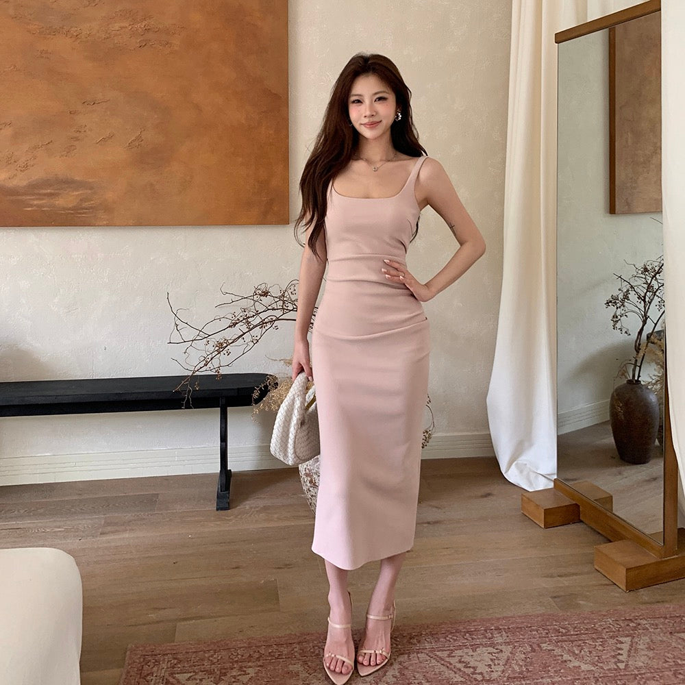 Woman in a light pink form-fitting midi dress