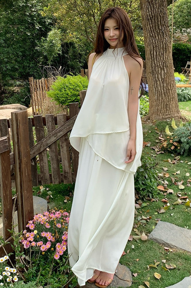 Full length view of a woman in a white halter top and A-line skirt set