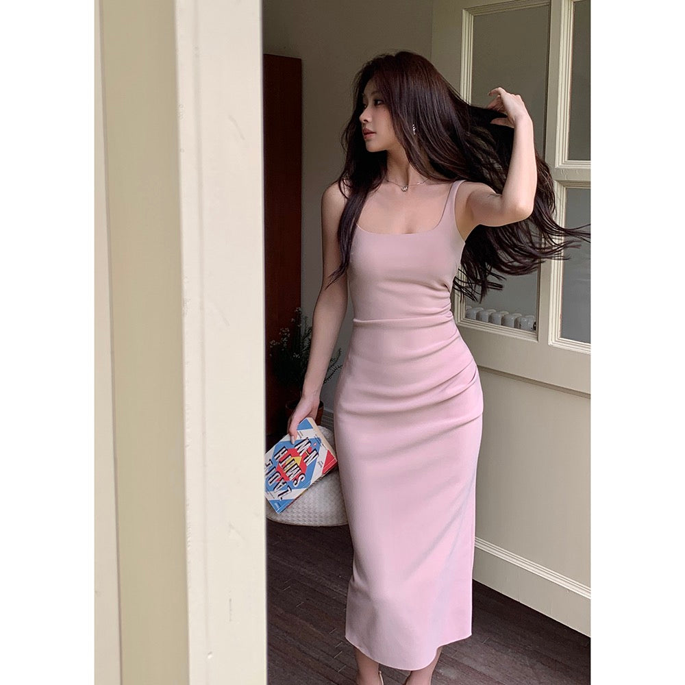 Woman modeling a light pink square neck camisole dress