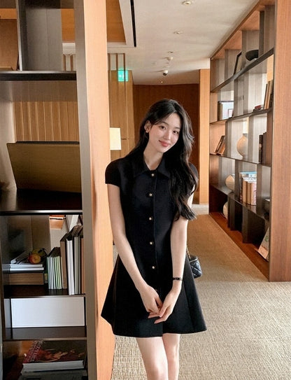 Elegant black dress with gold buttons