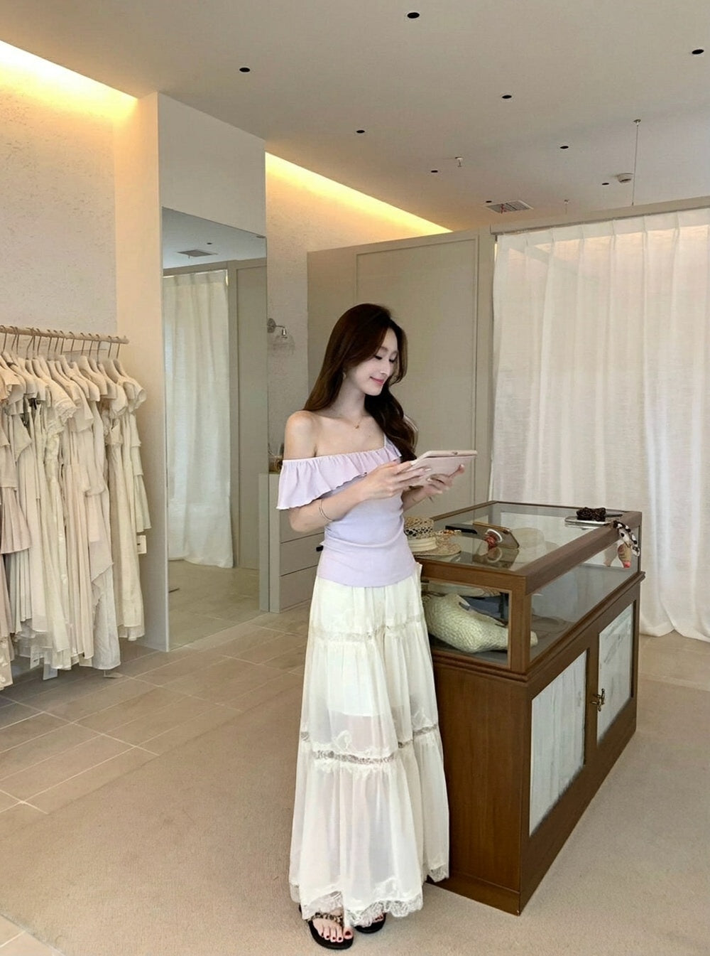Model posing in white heavy lace spliced midi skirt