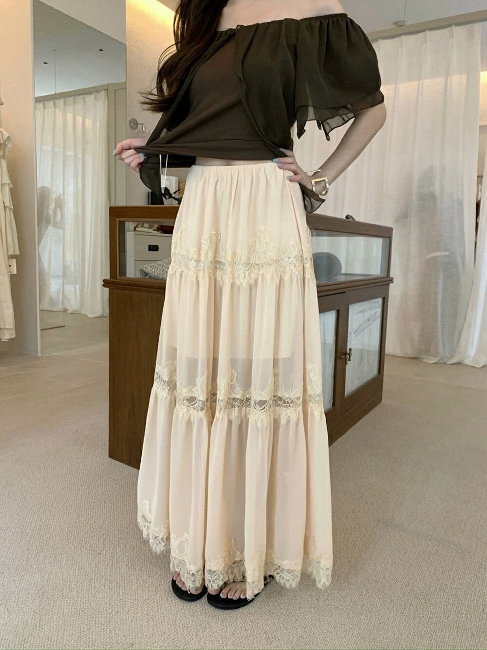 Model posing in apricot heavy lace spliced midi skirt