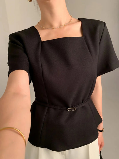 Close-up of a black square neck short-sleeve peplum top