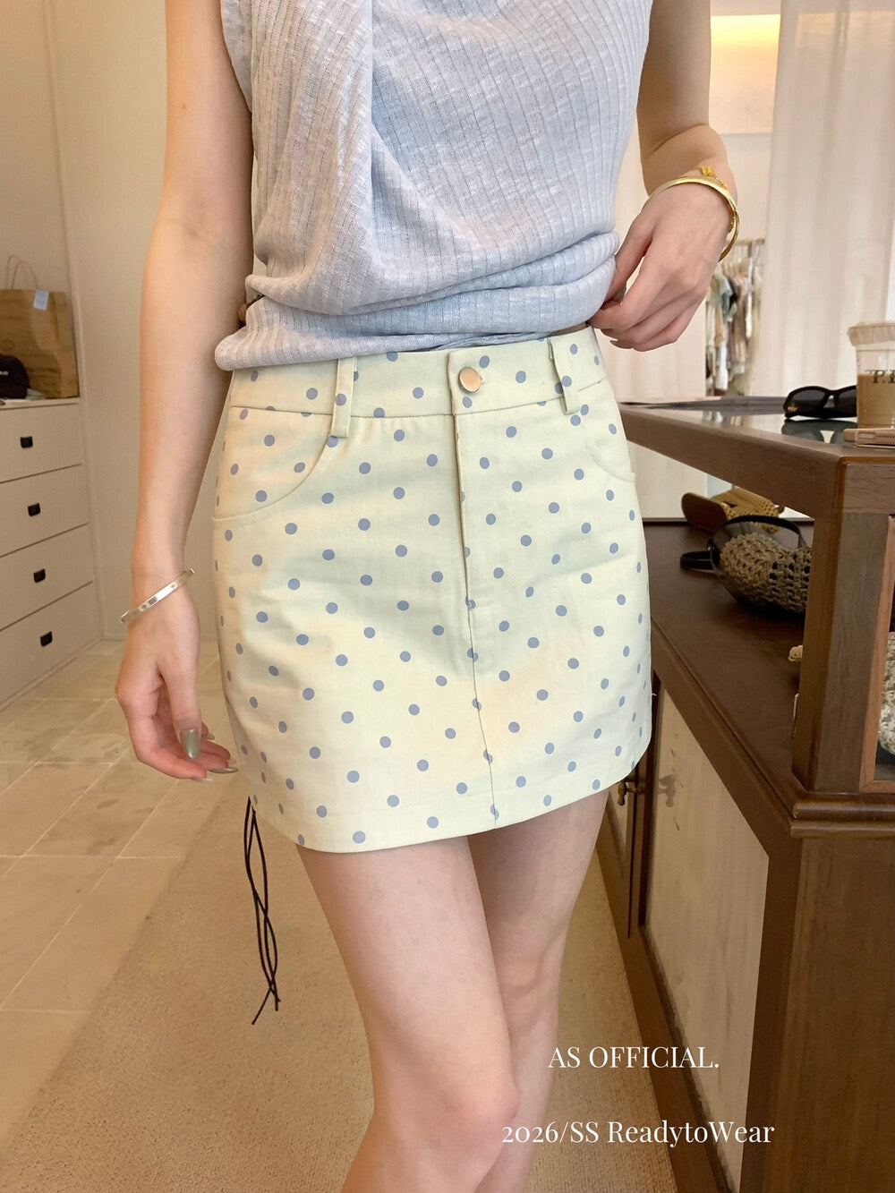 Model wearing apricot polka dot A-line mini skirt