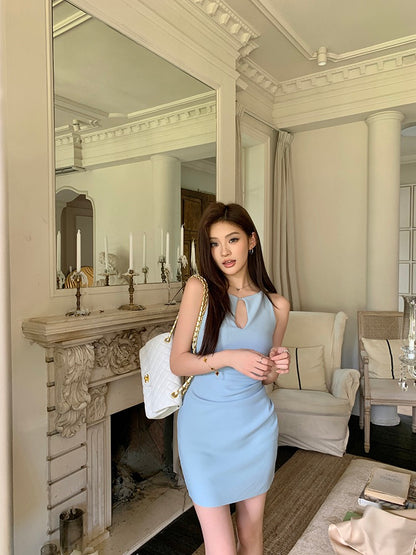 Model wearing a light blue keyhole sleeveless mini dress posing indoors