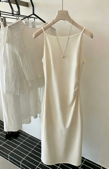 White sleeveless dress hanging on a hanger