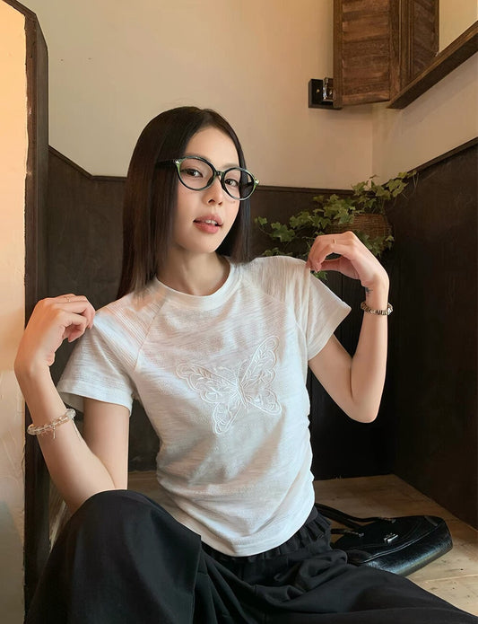 Model wearing white butterfly embroidered t-shirt