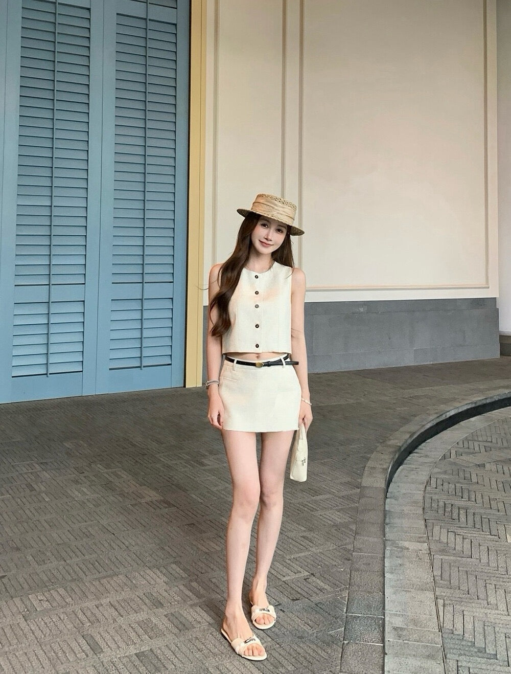 Woman standing outside in beige vest and skort set