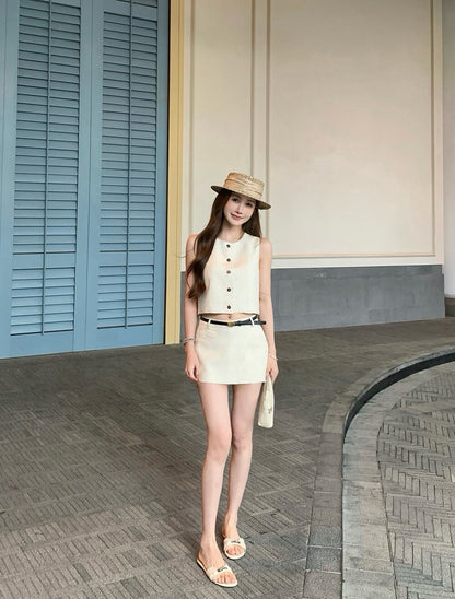 Woman standing outside in beige vest and skort set