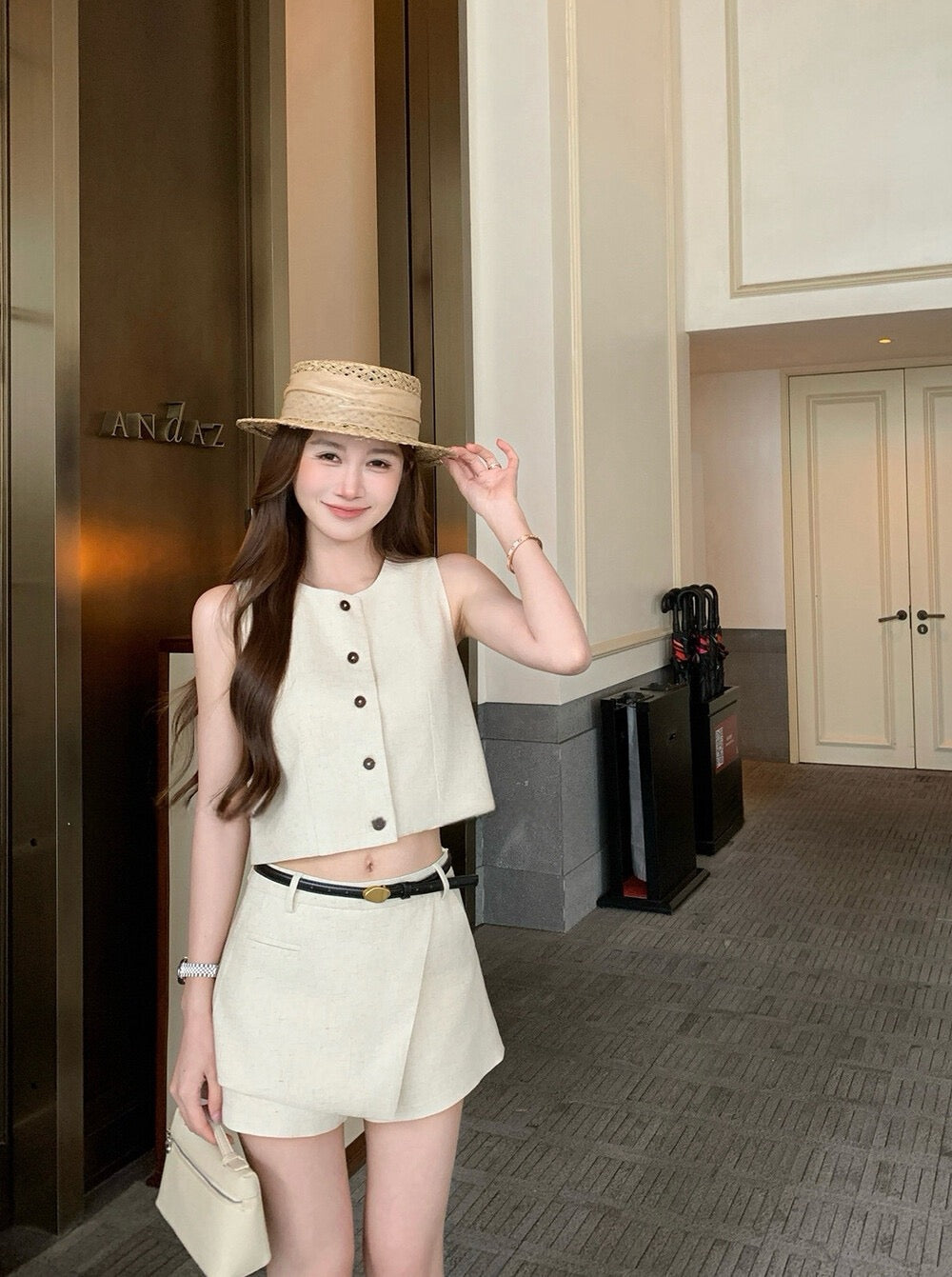 Full body shot of woman in beige two-piece set