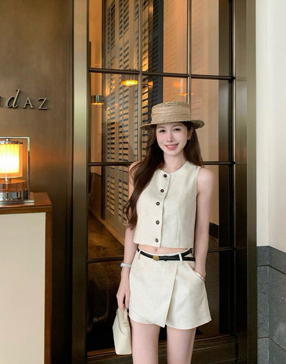 Half body shot of woman in beige vest and skort set