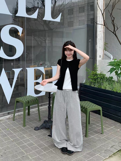 Model wearing a black faux two-piece short sleeve shirt full body