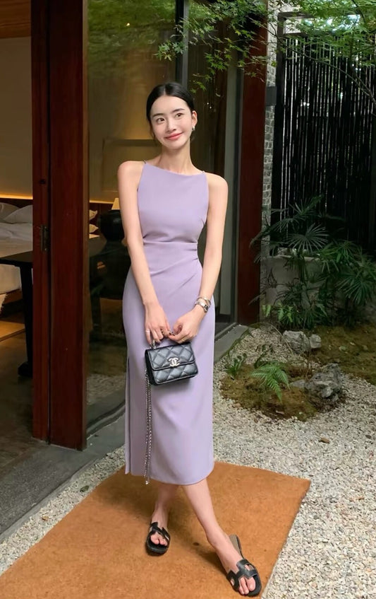 Woman modeling a light purple sleeveless midi dress with side slit