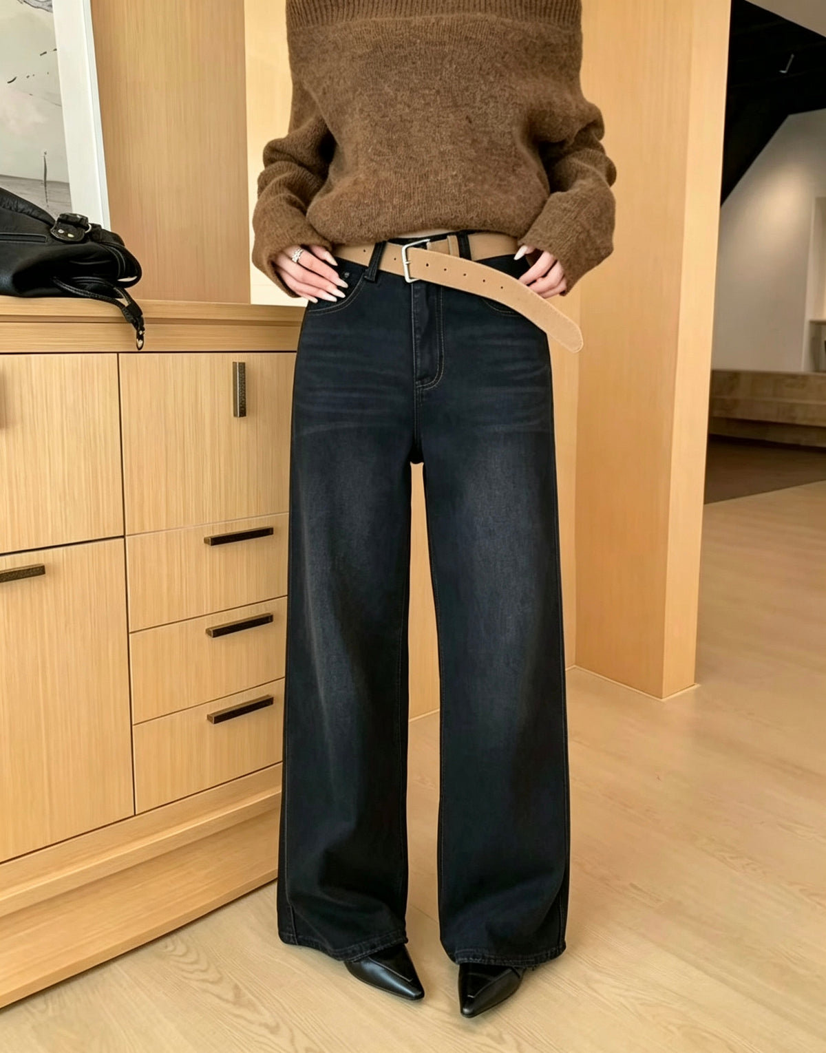 Model wearing black straight jeans
