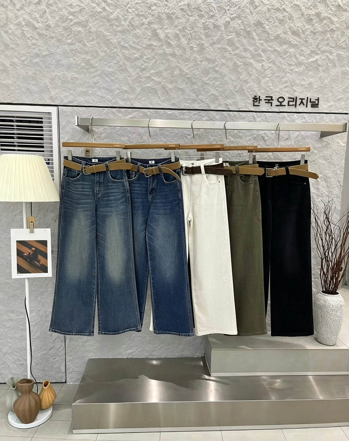 Five colors of straight jeans on a rack