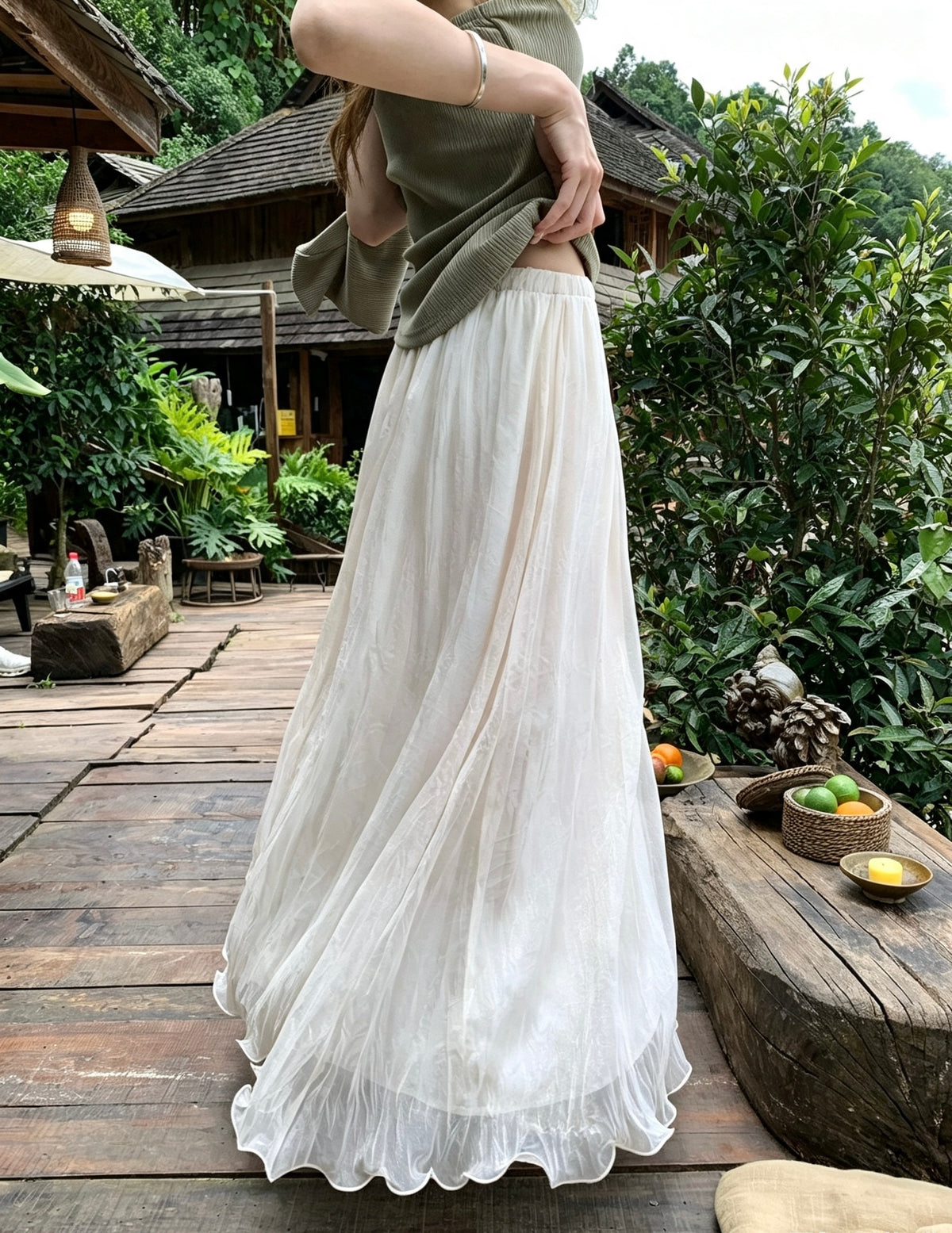 Model twirling in the flowy apricot mesh skirt outdoors