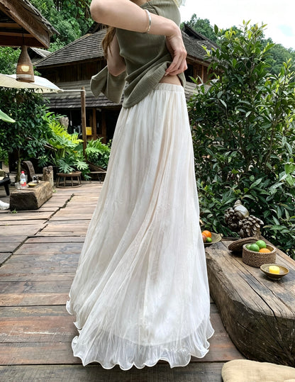 Model twirling in the flowy apricot mesh skirt outdoors