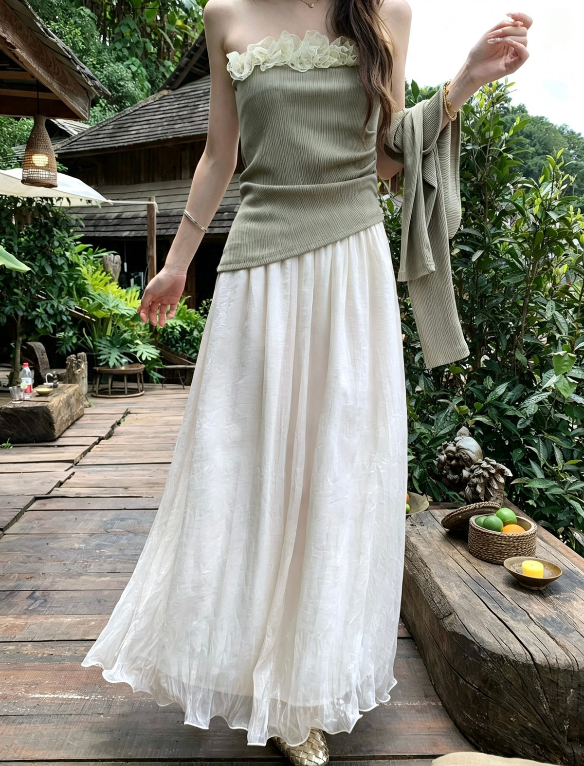 Model wearing the apricot mesh skirt paired with an olive green top