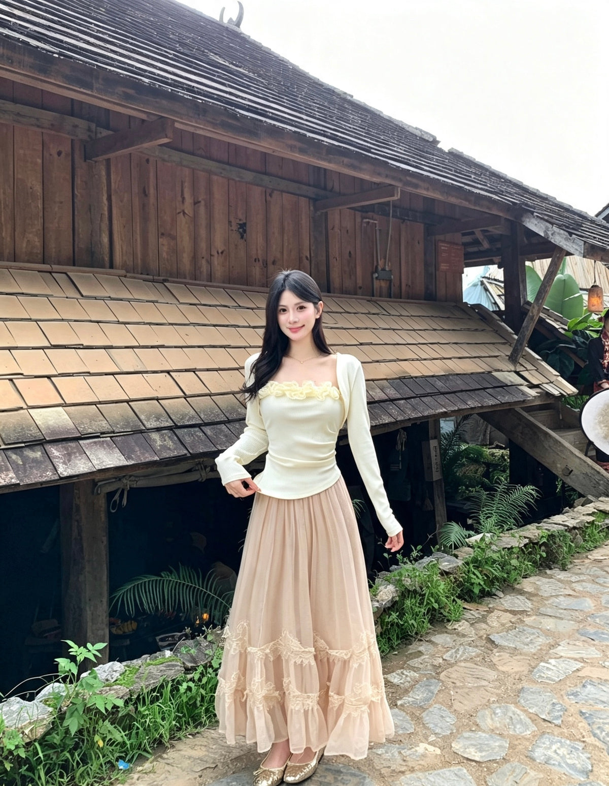 Model standing wearing peach tulle skirt