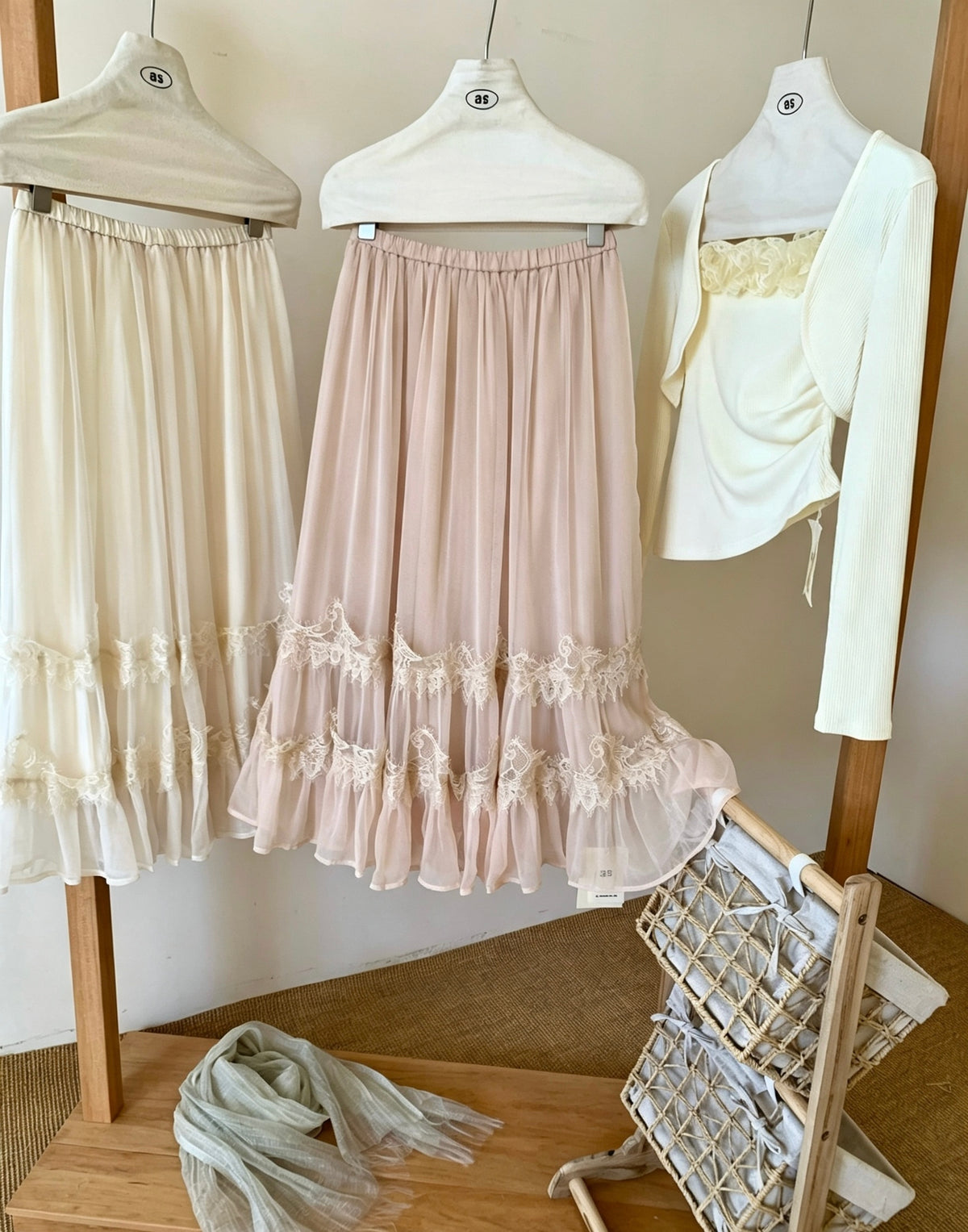 Apricot and peach tulle skirts hanging on rack