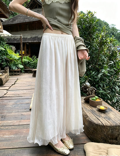 Model wearing the apricot pearlescent mesh skirt outdoors on a wooden deck