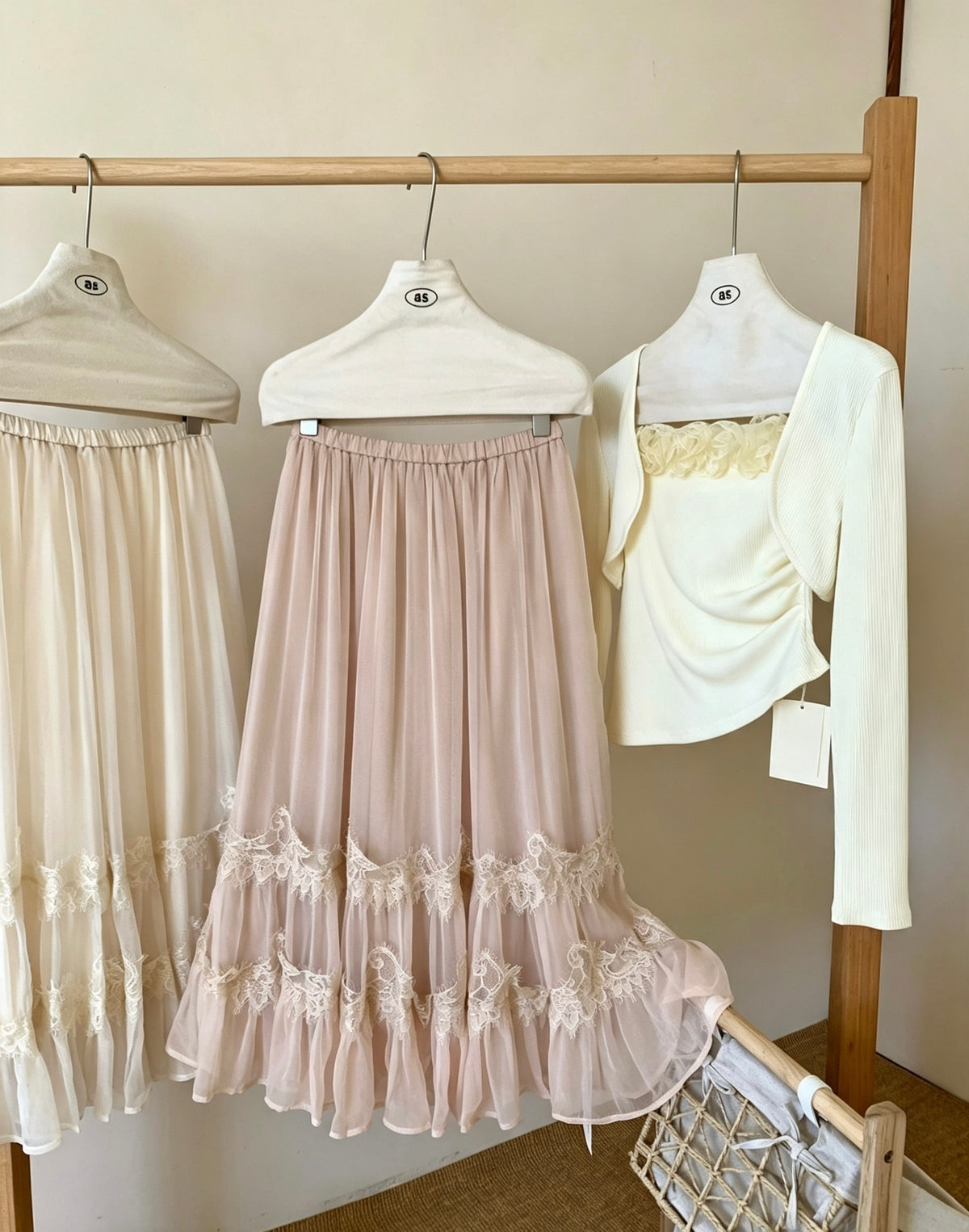 Apricot and peach tulle skirts hanging on rack