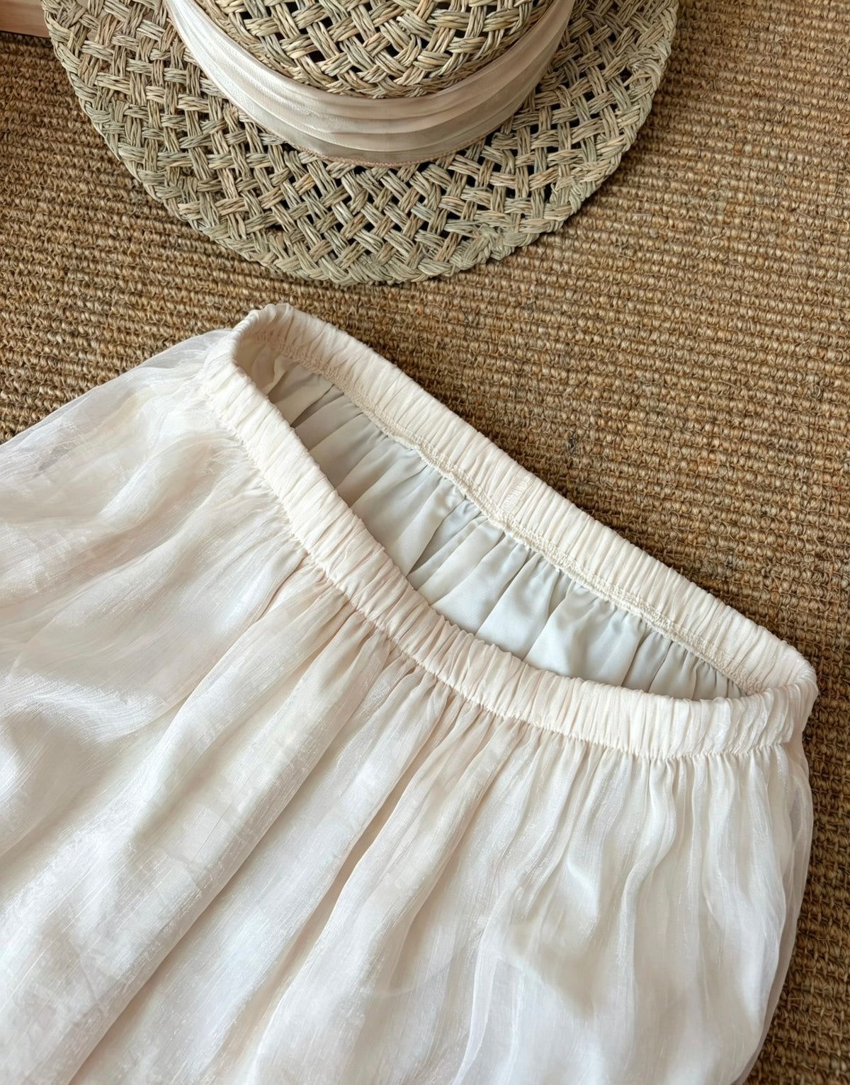 Close-up of the elastic waistband on the apricot mesh skirt