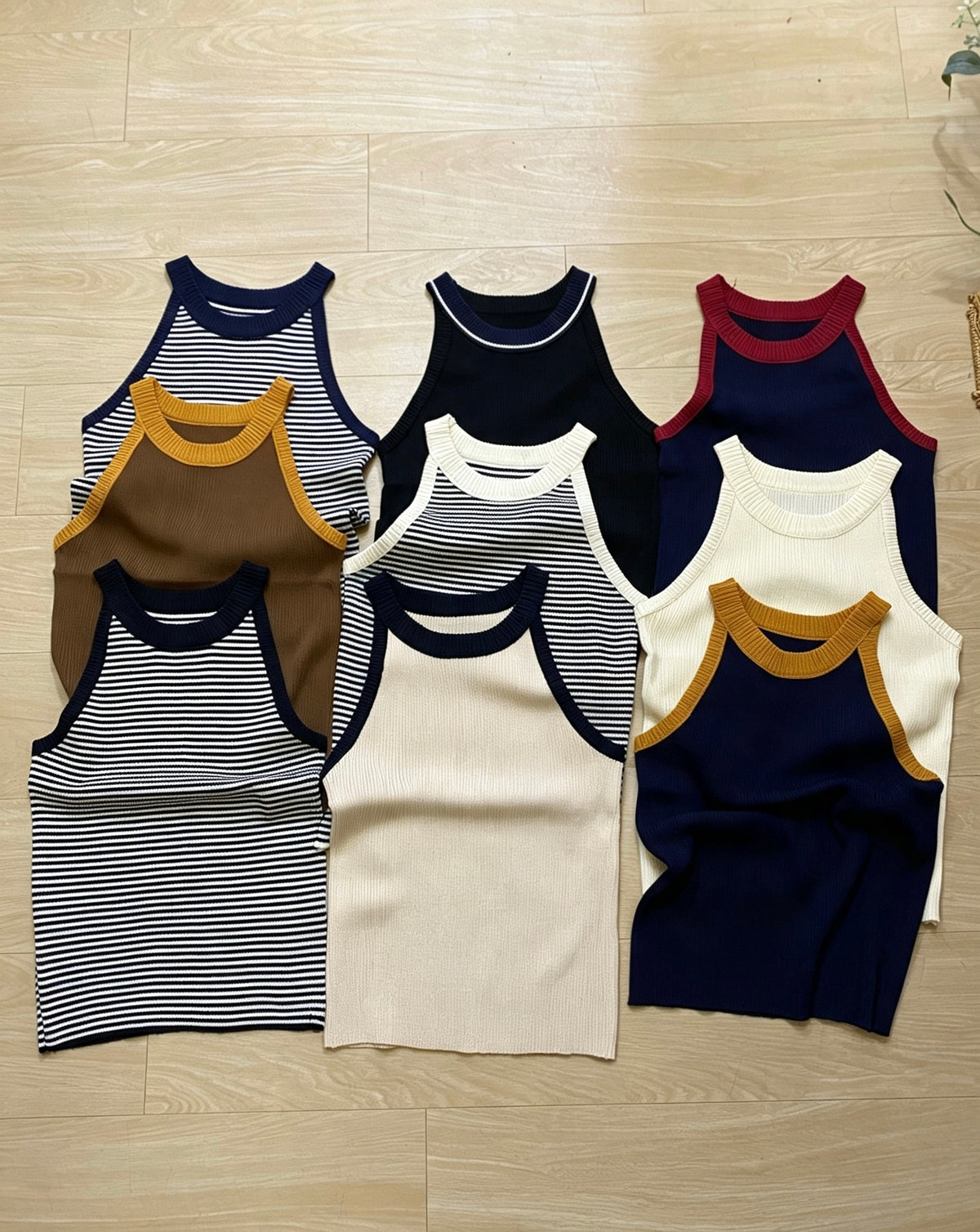 Flat lay of ribbed knit halter tops in various colors and striped patterns