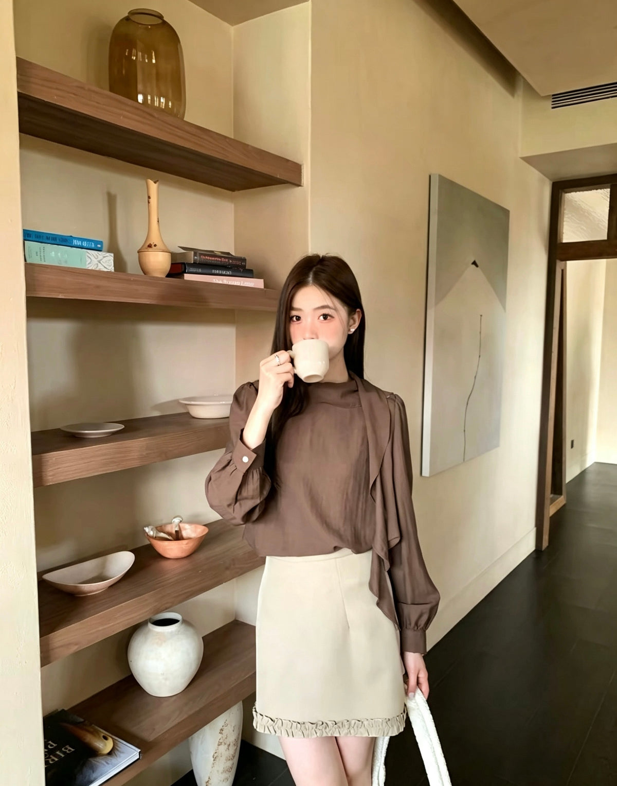 Model wearing a brown French design shoulder button tie blouse