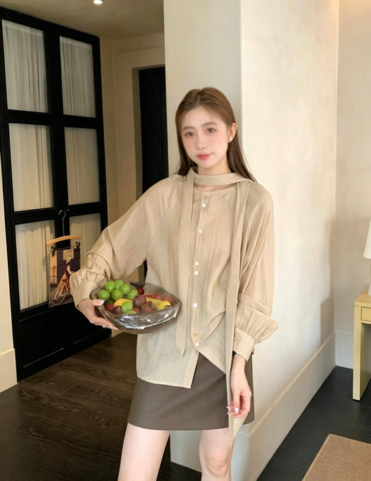 Model wearing a khaki two-way tie blouse and brown skirt.