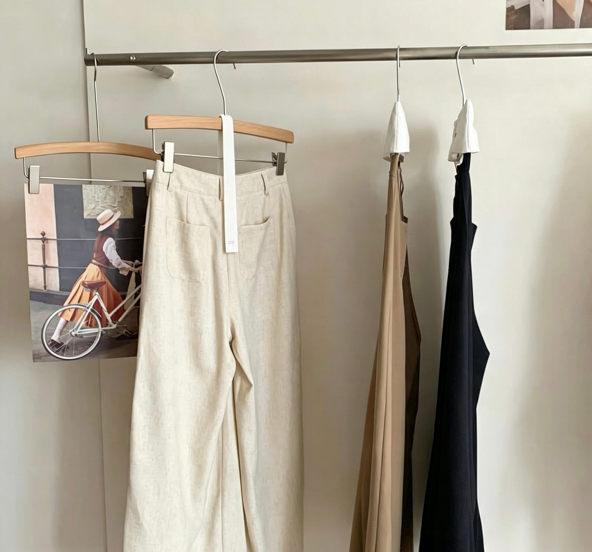 Side view of the linen trousers hanging on a rack.